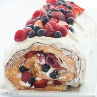 This Triple Berry Angel Food Cake Roll is an easy red, white and blue dessert (or just red and white!) for the 4th of July or Canada Day, or any day! Perfect with fresh summer strawberries, raspberries and blueberries Includes step by step recipe video. #video #recipe #recipevideo #cake #dessert #strawberry #blueberry #raspberry