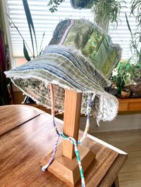 Many a vintage cotton quilted together create a wonderful textured hat Reverse to a green toile for double the sun fun Chin tie helps on windy days Size small/medium  23 inch  3.5 inch brim