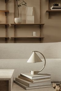 Meridian Lamp - Rico Sofa - Sector Shelves - Speckle Pot. The Meridian Lamp presents a portable, dimmable lighting solution that works in a multitude of settings. Made in collaboration with the design studio Regular Company, the intriguing, sculptural form of the Meridian Lamp is based on three simple geometric elements. Combined, the lamp presents a clean, modern expression. The lamp offers easy, hassle-free charging, and provides up to 12 hours of light at a time.