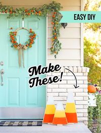 These big candy corn are made of wood. Easy DIY for fall and the best part is that they are reversible. Click the link to see what's on the back side! SO SMART!! Love this porch decorated for fall.