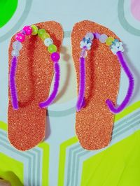 Flip flops /slippers made with glitter foam, pipe cleaners and beads.