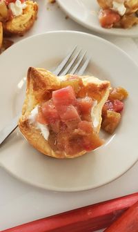 Flaky puff pastry tarts filled with a creamy mixture of cream cheese and yogurt, all topped off with juicy, tangy rhubarb.