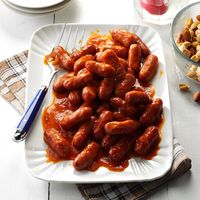 Party Franks Recipe -These tiny, tangy appetizers have such broad appeal. I prepare them often for holiday gatherings, weddings and family reunions. They're convenient to serve at parties since the sauce can be made ahead, then just reheated with the franks before serving. —Lucille Howell, Portland, Oregon