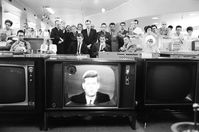 A large group of customers in California gathers in an electronics department to watch as President Kennedy delivers a televised address to the nation on the the Cuban missile crisis.