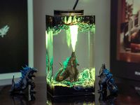 Monster God, Atomic Breath, Monster Night Light, Handcrafted Gift, Desk Decor. You're not just owning a lamp, but also a unique piece of art that embodies the eerie style of the king of all monsters. With a realistic design, the image of God is faithfully reproduced in layers of resin, creating a small statue exuding undeniable power and authority. With meticulous attention to detail, this lamp is not only a unique decorative piece in your space but also a distinctive highlight when illuminated in the dark. With gentle light emanating from within, this lamp creates a warm and mysterious atmosphere, perfect for creating focal points in your living room, bedroom, or workspace. You can enjoy living space with the powerful presence of God and feel the strength of the legendary monster every da