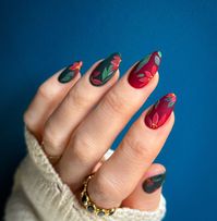 This festive nail design combines deep green and rich red hues with delicate floral patterns. The vibrant colors and intricate details create a look that is both bold and sophisticated, perfect for celebrating the holiday season in style.   Photo credit by: @paiwaloves