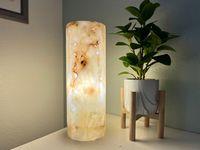 100%  Onyx Stone Hand carved                                                                 * BEAUTIFUL ONYX TABLE LAMP                                                                             15.75" High x 5.75" Diameter   This beautiful hand-crafted Onyx Lamp, adds elegance to your space, once lit you can see the beautiful veining of this translucent stone as it offers a warm light, creating a serene atmosphere you will enjoy. Onyx is often used in meditation and also helps improve mental