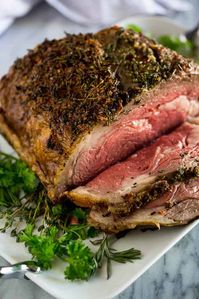 A slow roasted Prime Rib recipe, seasoned with garlic and herbs, with step by step instructions and tips for making perfect boneless or bone-in prime rib.