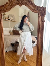 cowgirl boots flowy white dress with sweater over sage sweater dress layering spring outfit inspo 