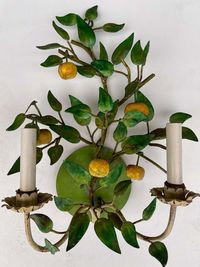 For Sale on 1stDibs - This is a set of Italian toleware fruit and foliate sconces. They are electrified. The yellow fruit appears to be an apple. They do show some age wear