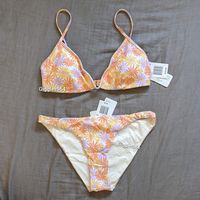 New With Tags. Top Has Adjustable Straps, Band, And Removable Cups. Bottoms Are Camacho Classic Cut. Also Available In Other Cuts Such As Cabana And Joy, See My Other Listings. Oopsie Daisy Orange/Yellow/Purple Print On Cream