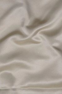 Butter Cream Silk Duchess Satin Fabric is a heavyweight, luxurious, soft, and shiny fabric with a beautiful pearly sheen and a matte back. Gracious and stylish fabric for special occasion garments that characterizes with crisp volume very easy to work with. The fabric is sold by the Yard, and measures 54 inches in width.