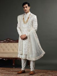 Stay stylish in the freshest collection of sherwani. Opt for the off white raw silk sherwani adorned with embroidery, resham, cutdana, zari, applique and beads work. It comes with a bottom.