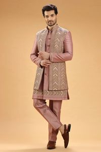 Elevate your wedding look by adorning this mauve pink indowestern crafted in silk fabric. Nicely decked with embroidered, resham and sequins work. It has a mandarin collar, a full button placket and full sleeves. It comes with a bottom.