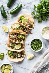 This easy carnitas recipe can be made in the slow cooker or Instant Pot for foolproof Mexican pulled pork that's juicy and flavorful. Perfect for tacos, tostadas, gorditas, burrito bowls and more! (gluten free, paleo, low carb) #carnitas #mexican #tacos