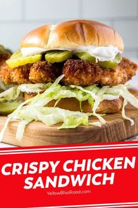 The ultimate Crispy Chicken Sandwich has a perfectly fried chicken breast piled high with lettuce and pickles stuffed into a brioche bun.