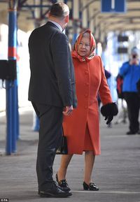 Heading home: The Queen looked in good spirits as she boarded the train at King's Lynn, in...