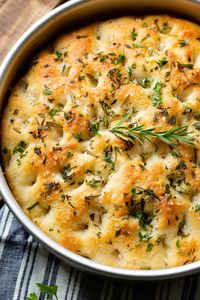 It's just a simple bread, light and airy, a yummy olive oil saltiness and those fresh herbs bring the whole loaf to life. Use it as a side or to build delicious sandwiches! This is our recipe for the Easiest Herbed Focaccia Bread! I want to dip this in some yummy soup! #bread #focaccia #side #sidedish #sandwichbread #herb #oliveoil #yeast