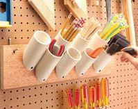 Corral skinny things: Saw off short pieces of 1-1/2-, 2- or 3-in. PVC plumbing pipe with 45-degree angles on one end. Screw them to a board to hold paintbrushes, pencils, stir sticks and just about any other narrow paraphernalia in your garage. Mount them by drilling a 1/4-in. hole in the angled end, and then drive a 1-5/8-in. drywall screw through the hole into the board.