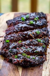 Smoked Spicy Asian Pork Ribs are cooked low and slow on your Traeger Pellet Grill before getting an Asian sauce smothered all over them for a braise that leaves these ribs so tender that they fall off the bone.