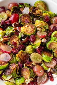 Roasted Brussels Sprouts with Cranberries! These are also tossed with grapes, pecans, and balsamic glaze. These brussels sprouts with cranberries are the perfect side dish for the holidays.