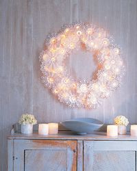 Paper doilies and bouquet holders with white string lights on a wreath form = lovely! Try it with foil doilies and colored lights too! http://www.partylights.com/String-Lights-Sets