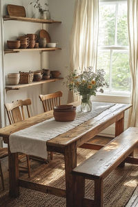 Cottage Core Dining Room features a shabby chic dining room inspired by rural life, with a focus on homemade charm and simplicity. The room is filled with handmade wooden furniture and simple floral patterns, evoking a sense of comfort and nostalgia. The overall design is functional and unpretentious, perfect for family meals that feel grounded and homey. This dining room is ideal for those who cherish simplicity and the rustic appeal of cottage living. For more cottage core dining room ideas, click or tap here.