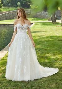 Off the shoulder lace a-line bridal gown with semi-sheer sweetheart top. Available off the rack at Silk Bridal Studio.