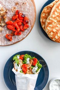 Greek Chicken Pita with Yogurt Sauce is a simple 30 minute weeknight meal. Marinated greek chicken loaded onto a warm pita with lettuce, tomatoes, and tzatziki yogurt sauce. Great for when you need a quick meal.