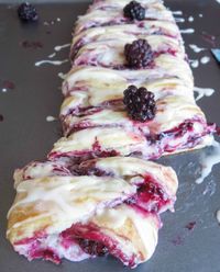 Vanilla Glazed Blackberry Danish Braid. Juicy, homemade blackberry preserves over a bed of sweet cream cheese, all wrapped up in a buttery, flakey dough. Absolutely amazing for breakfast or as a dessert!