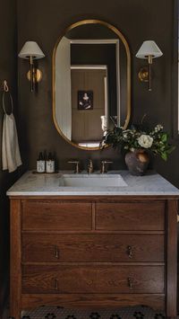 Creating a dark, moody vintage bathroom offers a unique blend of elegance, nostalgia, and intimacy. The deep, rich colors evoke a sense of sophistication and timelessness, while vintage elements infuse the space with character and charm. We love this vintage dresser turned vanity in this bathroom. Explore vintage pieces for your bathroom on Vinterior and create a one-off space. Images via modern_nest