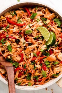 Chicken Pad Thai is a flavorful noodle stir-fry full of vegetables, chicken, rice noodles, eggs, and peanuts in a sweet and savory sauce. Make this popular dish at home in just 30 minutes! #thaifood #stirfry #asianrecipe | GarnishandGlaze.com