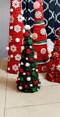 Such a cute tree. Wrapped in Christmas pine greenery Adored with green red and white Lush pom poms. Looks amazing Paired with my other trees. Makes a lovely edition to your Christmas decor.