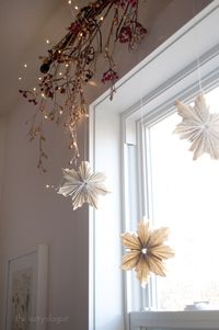 I made these folded paper snowflakes/stars out of old book pages and then gave them a light dusting of glitter for some sparkle! They look so pretty hanging in the window, catching the light as they move.