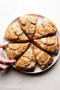 Delicious and flaky pumpkin scones with maple icing! The best pumpkin spice fall breakfast! Easy scone recipe on sallysbakingaddiction.com