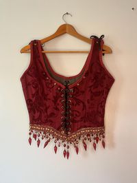 Red and Gold Reniassance Beaded Corset. Front and back lace up with adjustable straps for comfort. Neckline includes hand sewn individual beads. Corset is handmade in Ohio Measurements  Bust 35in-41in Waist 28in-34in