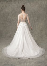 The Baylee wedding dress has a natural waist sparkle tulle A-line skirt with long sleeve illusion sweetheart lining. There is ivory beading through bodice and sleeves with buttons down center back. #wedding #weddingdress #longsleeveweddingdress #longsleevedweddingdress #weddingideas #weddingplanning #weddingdressstyles #bridalgown #ballgown #weddingdresses