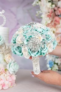 Enhance your quinceañera celebration with our stunning mint bouquet. This 9-inch floral arrangement features delicate mint-colored blooms, adding a touch of elegance and charm to your special day.  mint quinceañera bouquet, 9-inch bouquet, quinceañera flowers, elegant floral arrangement, mint-colored bouquet, quinceañera decor, floral centerpiece, special occasion bouquet, quinceañera floral arrangement, elegant mint bouquet