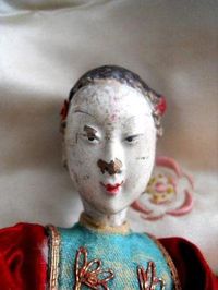 Antique chinese opera puppet with an exquisitely detailed and embriodered costume, and she has the most beautiful face.