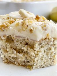 Amazing Banana Bread Cake topped with a thick and fluffy cream cheese frosting! Garnish this banana cake with banana slices and walnuts.