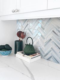 Experience the perfect blend of elegance and modern style with our blue textured glass herringbone tile, featuring a bright glossy finish.