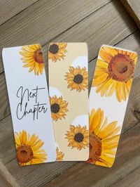 Bookmarks - Sunflower Bookmarks - Set of Three Bookmarks - Available with tassels or without  Bookmarks are printed on 65 lb cardstock with vivid colors. These bookmarks are laminated and the corners are rounded. The backside of each bookmark design is white. You have the option to choose bookmark only or bookmark with tassel. You also have the option to choose an overlay design.  Bookmark Dimensions: Approximately 2 in. x 6.5 in. How to Order: 1. Choose your bookmark option (with tassel or bookmark only) 2. Choose your paper option (Plain, Star, Gem, Dot, or Rainbow) Please note: The coloring may vary slightly depending on your viewing device.