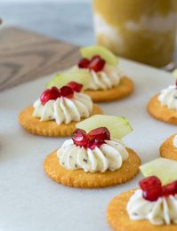 This easy cracker appetizer with cucumber, pomegranate, and seasoned cream cheese topping is always a hit with kids and adults alike. #cracker #partyfood #fingerfood