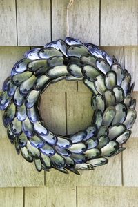 DIY:  How to Make a Coastal Inspired Shell Wreath - made using mussel shells, a wreath form, burlap ribbon and glue. This is a great project for a beach house - via Tilly's Nest