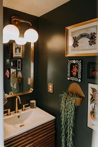 Paint color: 1905 green by Magnolia We sourced thrifted, vintage and new items to complete this gorgeous tattoo shop inspired bathroom for our completely tatted, punk rock loving client.