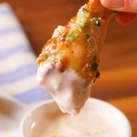 The idea of making chicken wings at home might seem tough—that crispy skin!—but we've mastered our method for perfect wings every time. Get the recipe at Delish.com. #delish #easy #recipe #wings #chicken #chickenwings #baked #garlic #parmesan #garlicparm #superbowl #fingerfoods #appetizers #snacks #cheesy