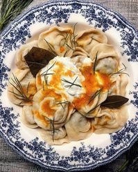 Pelmeni are Russian dumplings, made of simple dough, filled with minced meat and onion, boiled, and served with butter and sour cream.