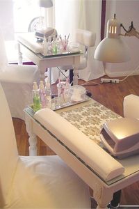 Each manicure station features a collection of treatment products, a UV light for curing, and an ergonomic wrist pad. Although the stations have an overhead light, an abundance of natural light streams in from the salon’s floor-length windows.