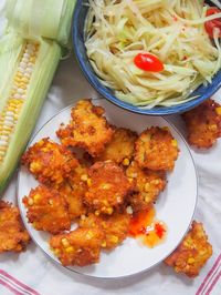 These Thai corn fritters (tod man khao pod) are addictively tasty little bites, packed with corn and flavored with bright lime leaves and red curry paste. They're easy to make, naturally gluten free and perfect for snacking on, or as an appetizer. 