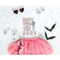 Get your little Ghoul ready for her Bad TWO The Bone Birthday Party! Listing is for one short sleeve t-shirt. Tutu and accessories not included.  This Bad to the Bone Halloween Toddler T-Shirt is PERFECT for: 🧡 2T and 3T Sizes  💜 Bad 2 the Bone Birthday Theme 🧡 Toddler Halloween Treat 💜 Halloween Boo Baskets 🧡 Last Minute Toddler Gift 💜 Terrible 2's Pride  🧡 Toddler Ghoul Gift 💜 Halloween Birthday  📏 Toddler Short Sleeve Size Chart: 2T: Chest 12 in./Length 15.5 in.  3T: Chest 13 in./Length 16.5 in.  4T: Chest 14 in./Length 17.5 in.  5-6T: Chest 15 in./Length 18.5 in.  Production time: 1-3 business days Shipping time: 2-6 days Delivery time: Usually within 3-9 days depending on your location and selected shipping. Care Instructions: - Inside out, wash with delicate cycle. - Lay fla